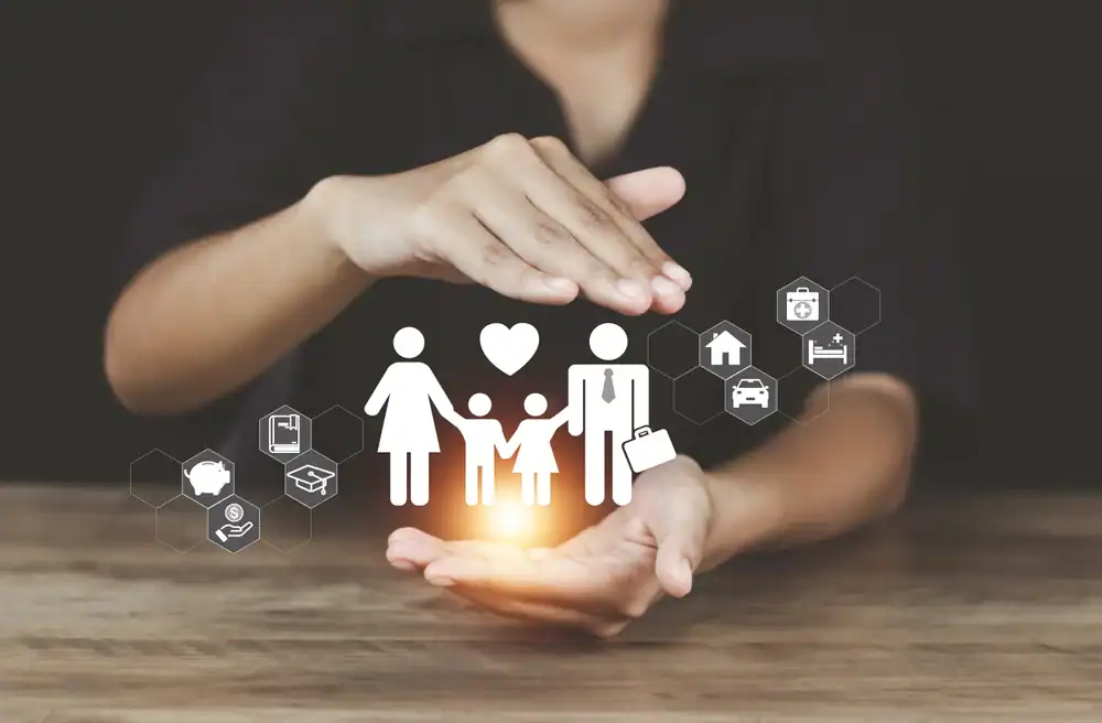A person&rsquo;s hands gently surround a glowing family icon, with symbols of health, home, and education floating around&mdash;representing the protection life insurance Orange County brings for your family and assets.